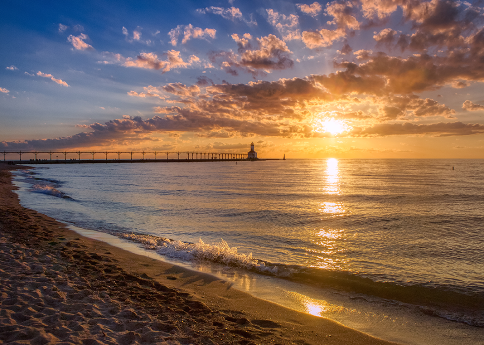 Sunset with dramatic clouds over Michigan City East Pierhead Lighthouse.