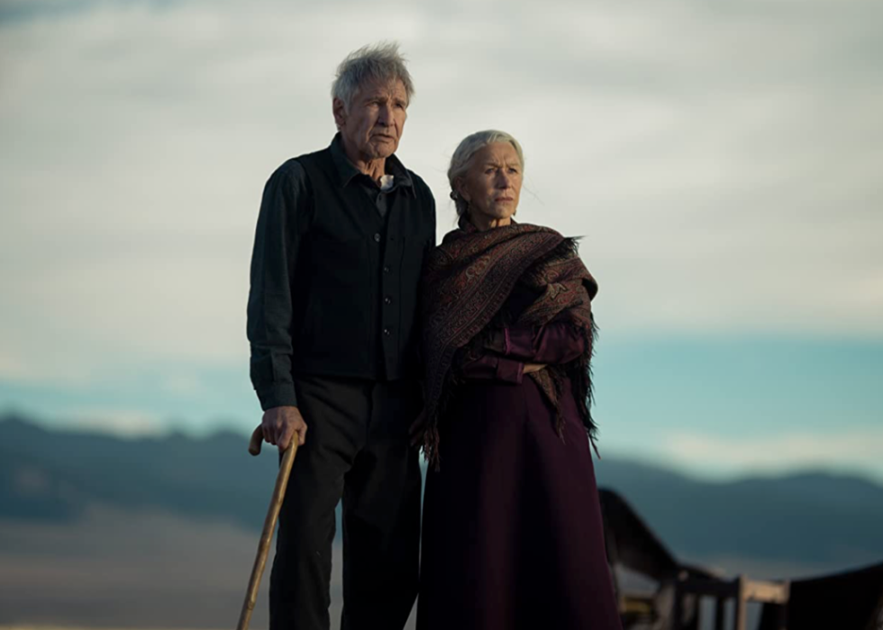 Two men talking on horseback.