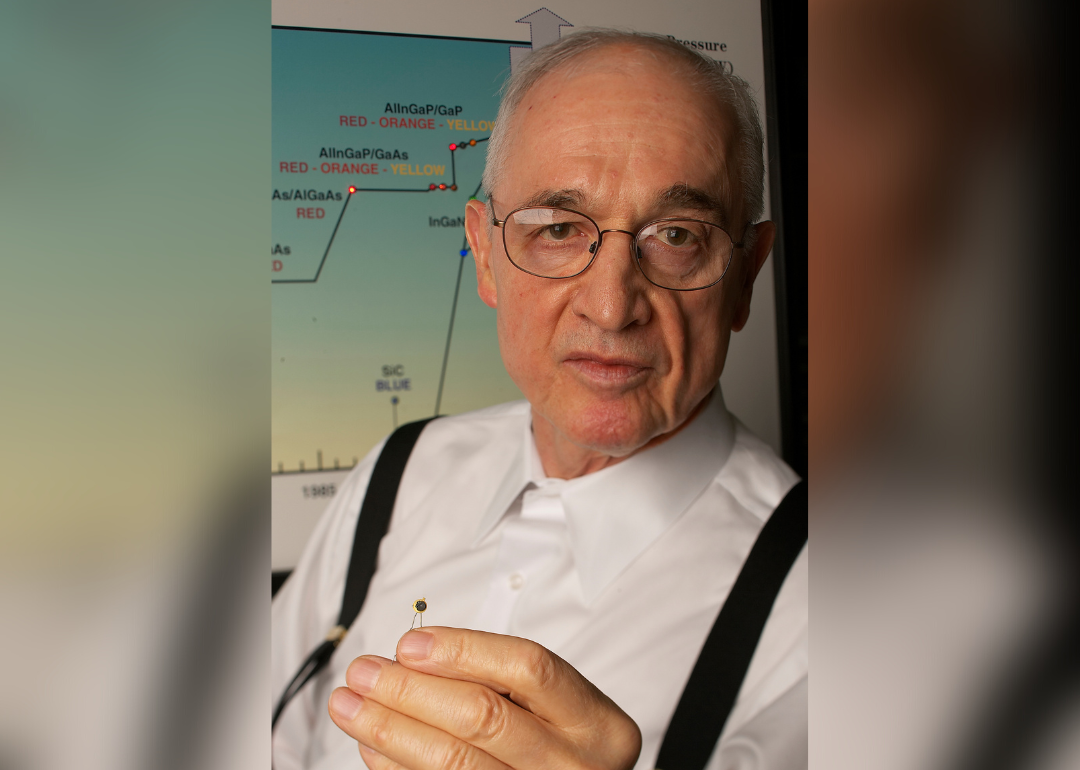 Professor Nick Holonyak holds a light-emitting diode.
