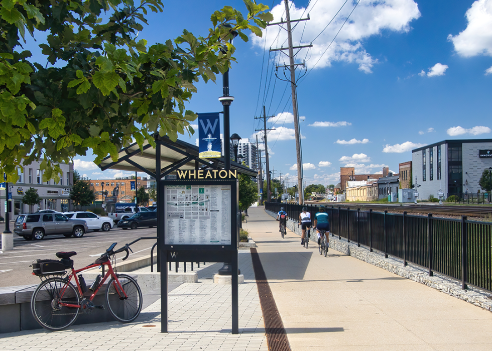 Sign for Wheaton beside train tracks along the Illinois Prairie Path.