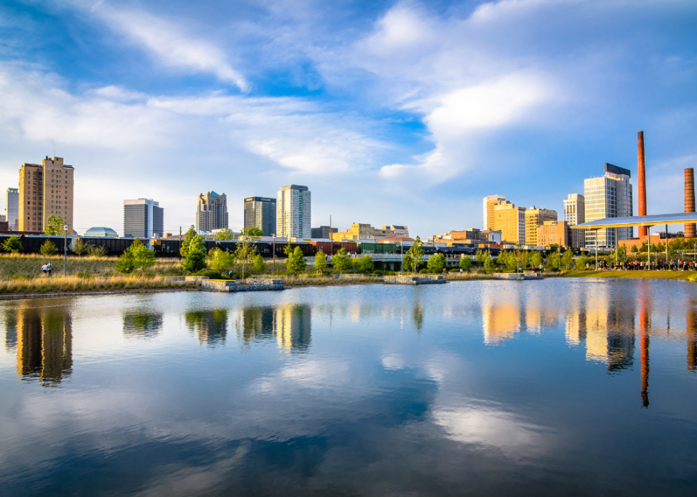 A view of a city situated by the river with tall buildings.