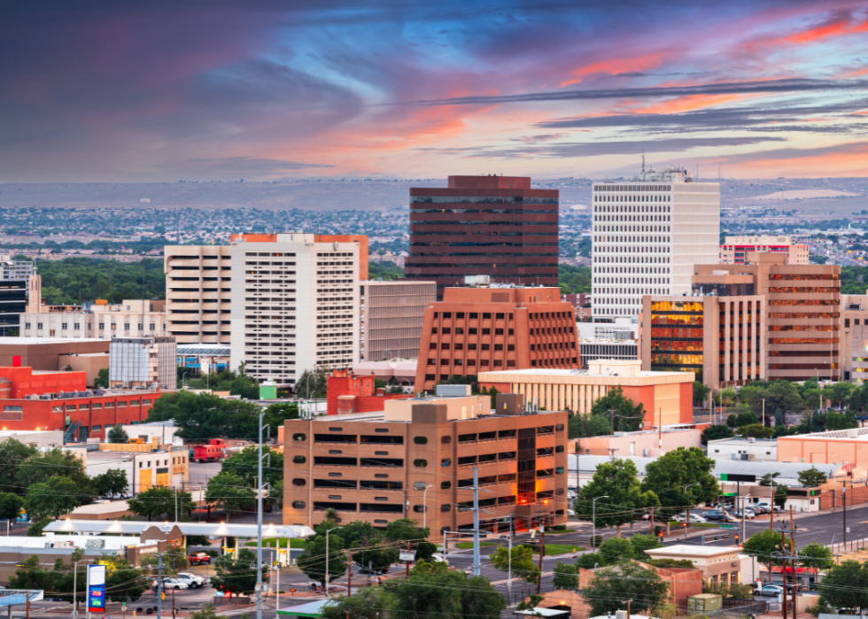 A city skyline with mountains in the background.