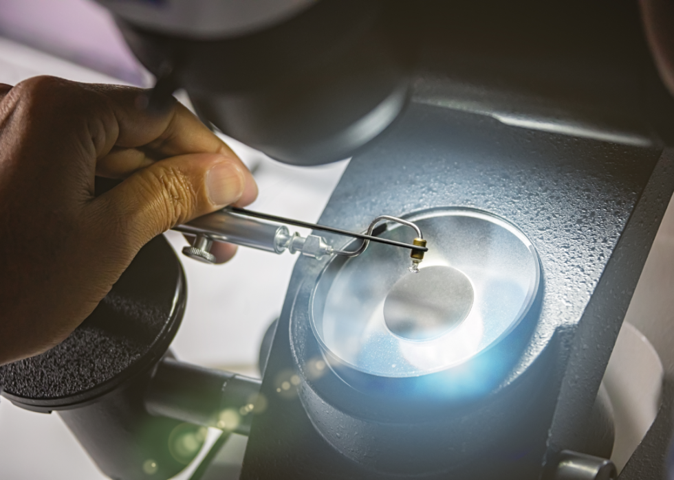 A diamond is closely examined in a laboratory.