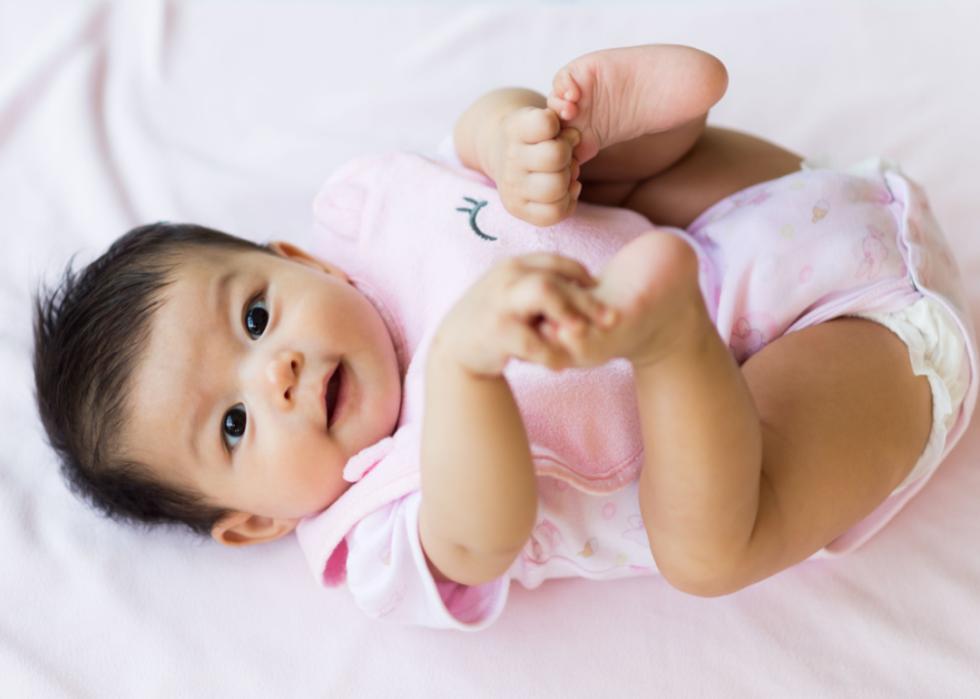 Asian baby lying on a blanket.