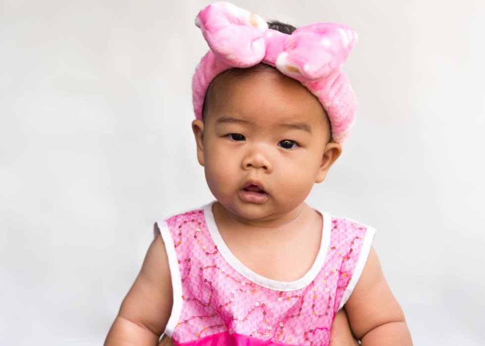 Asian girl in a large pink bow.