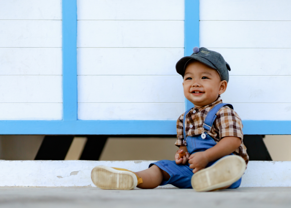 Asian boy sitting on the ground. 