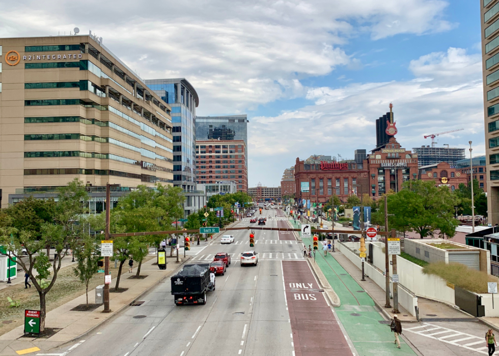A city traffic with tall buildings along the road. 