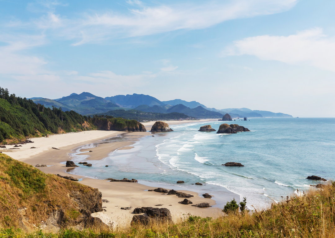A beautiful beach with mountains in the background.