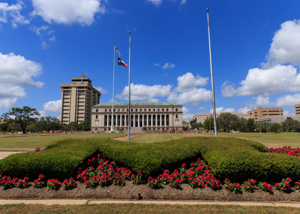 A garden and flags flying in front of Texas A&M.