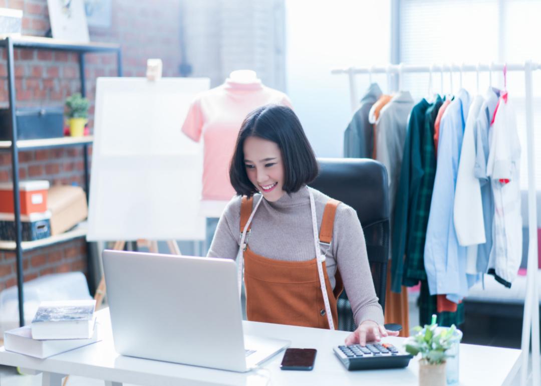 A woman at a laptop smiling.