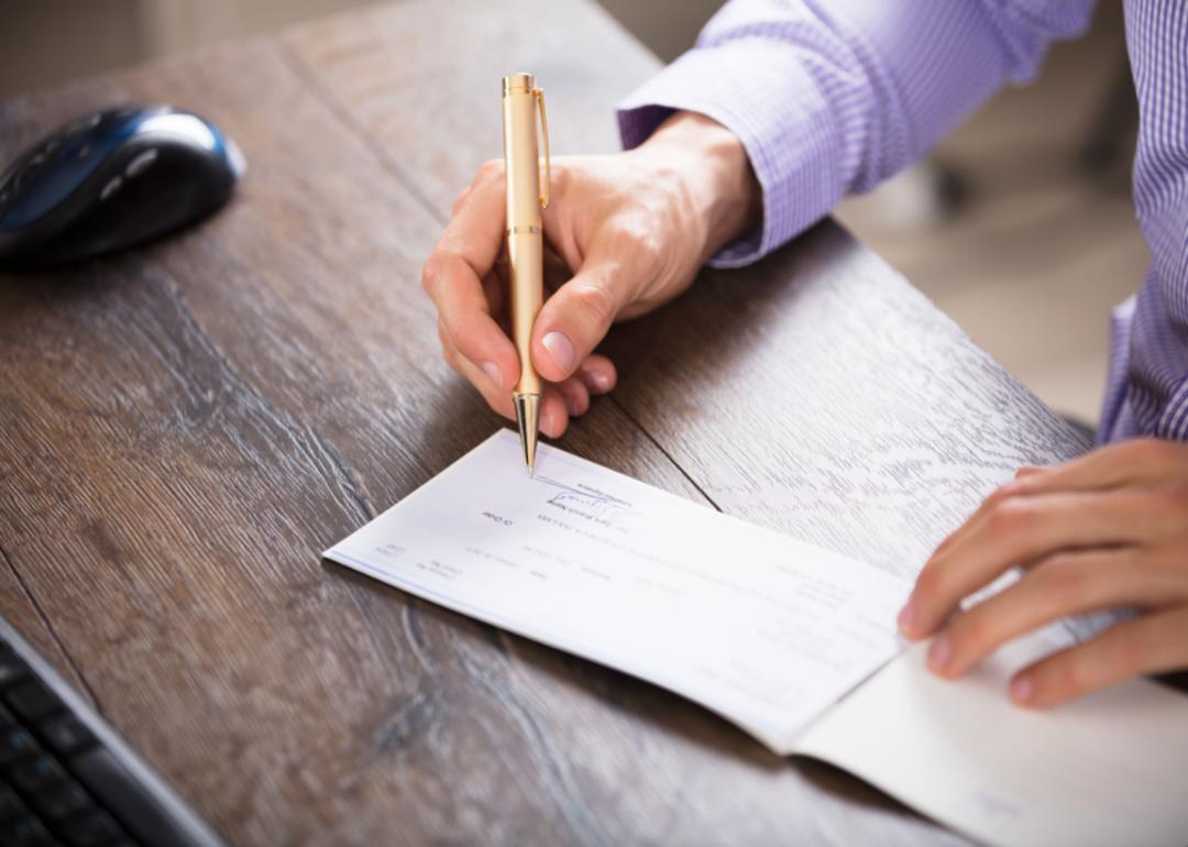 A man writing a check.