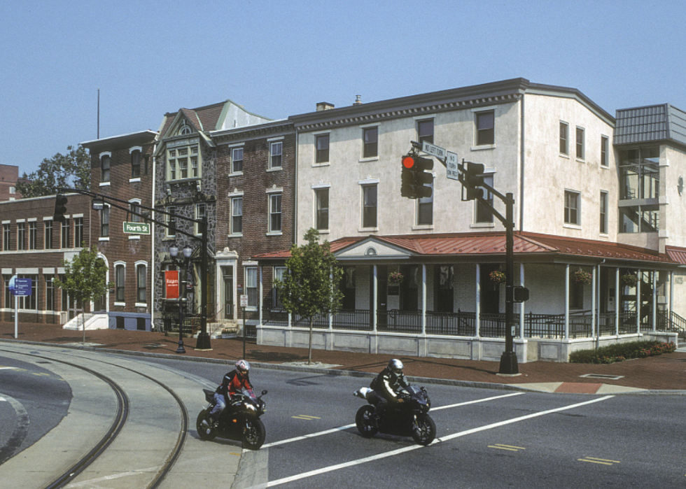 A row of red brick and white buildings.
