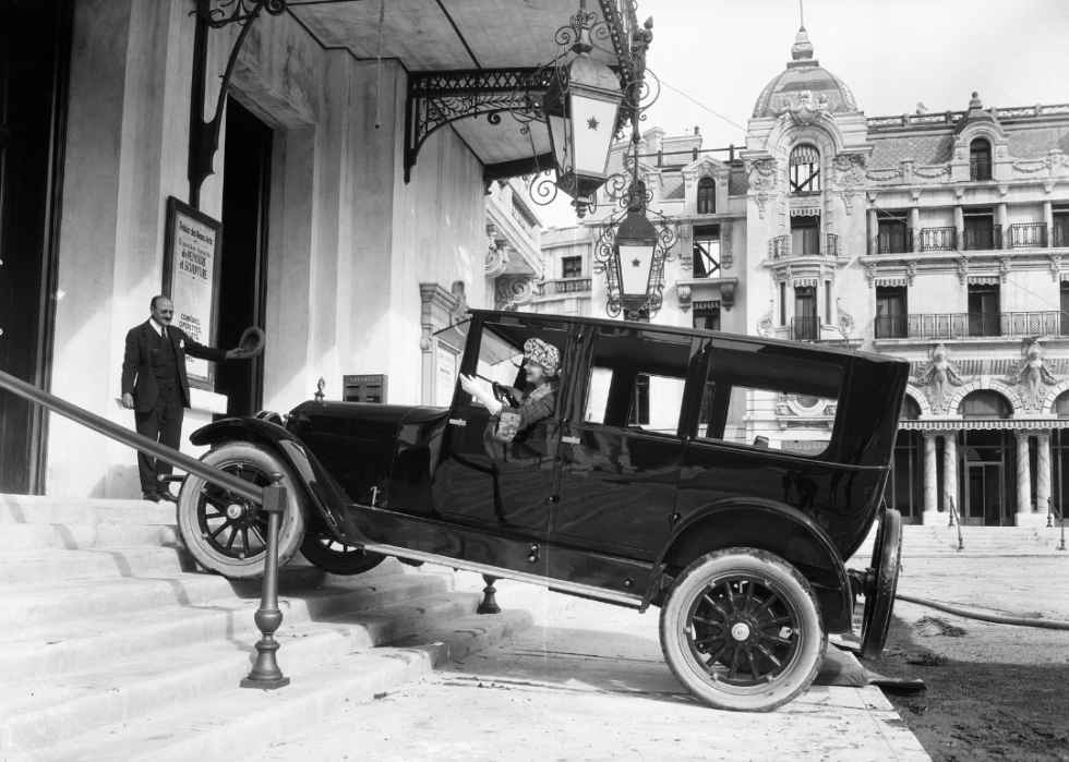 An actress drives a car into a casino on a studio backlot