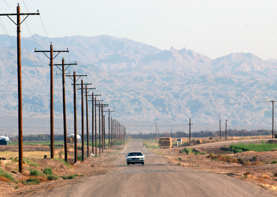 A car driving down a remote road in 2003.