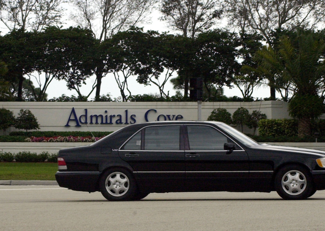 An automobile passing the gated community of Admira.