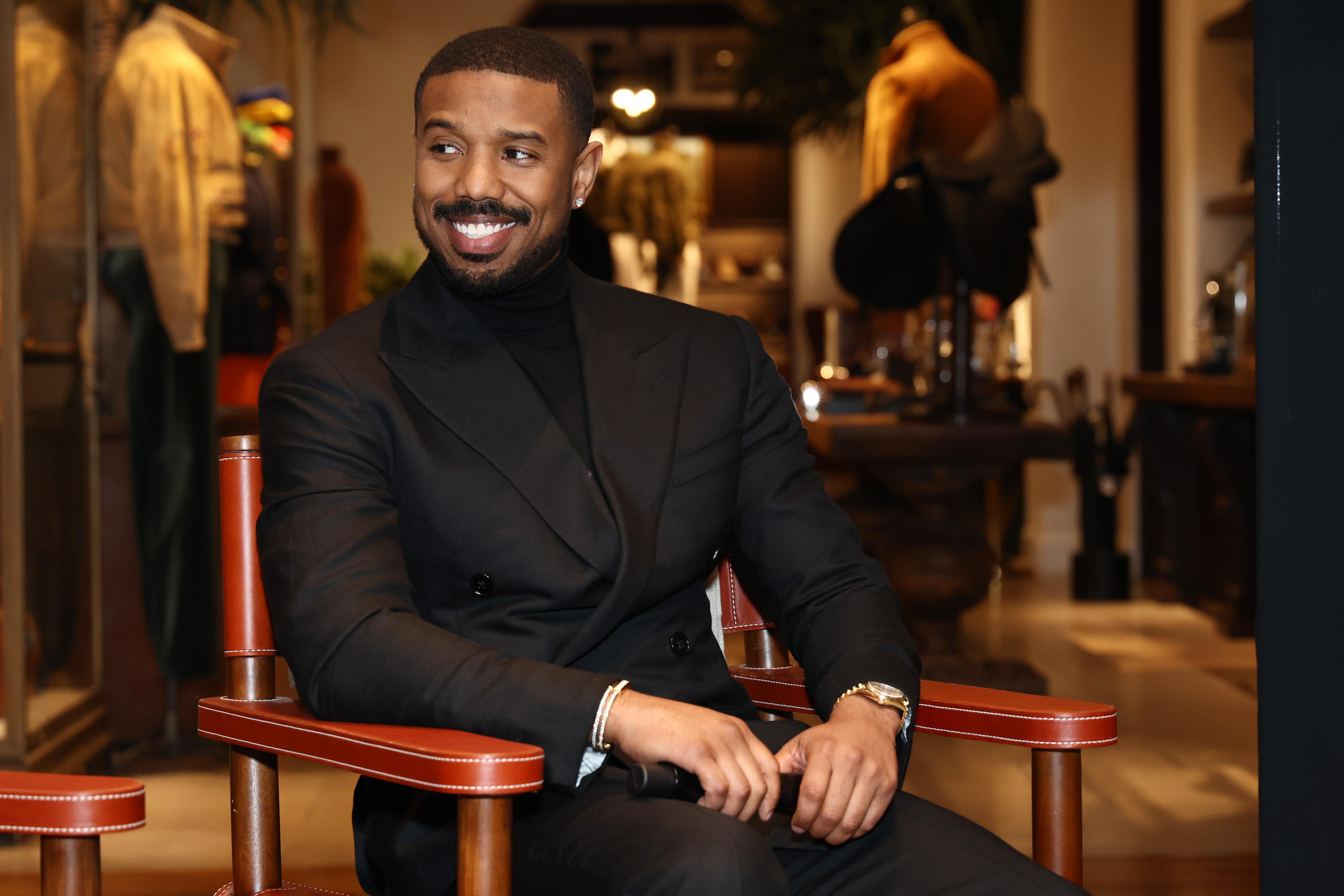 Michael B. Jordan in a black suit.