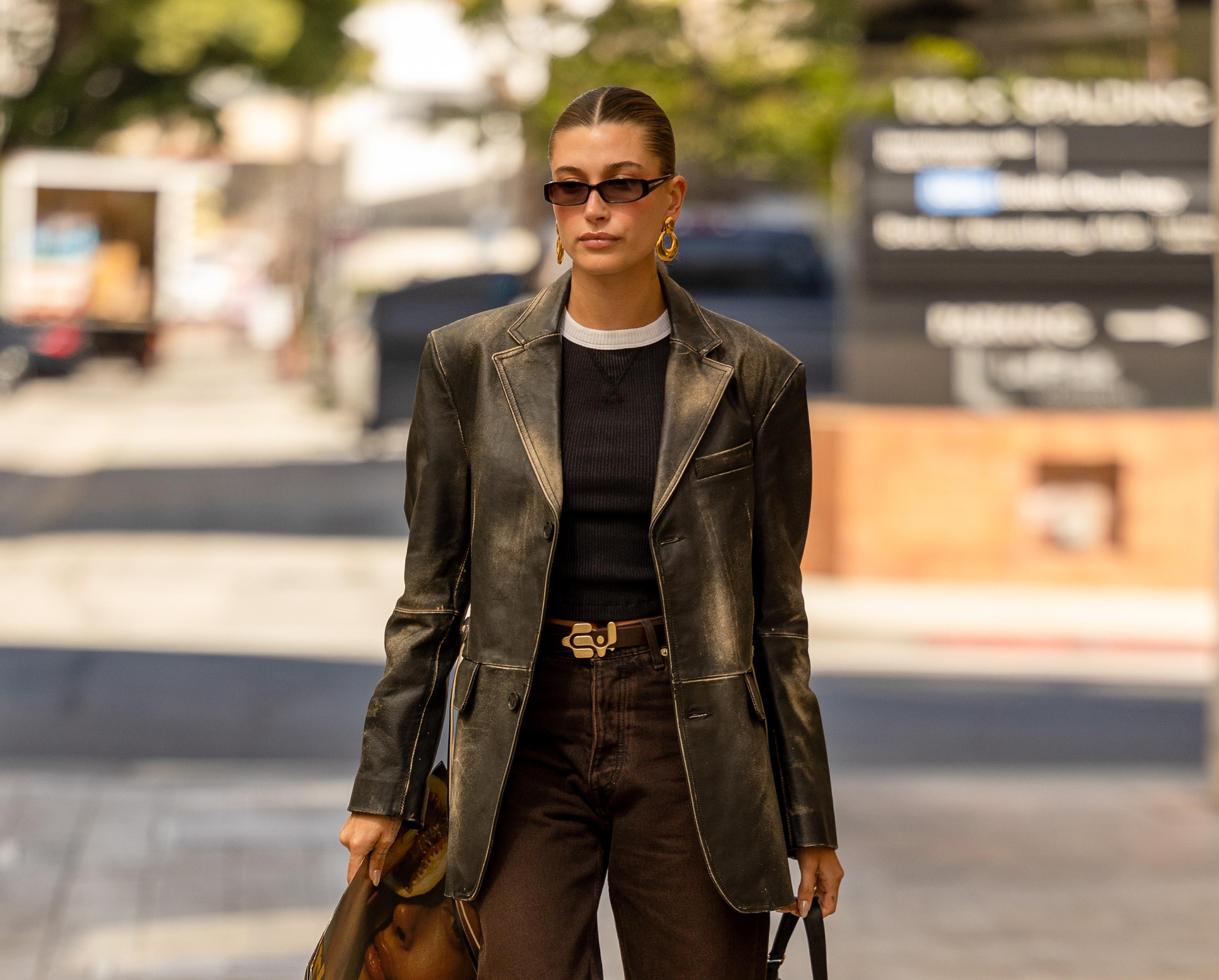 Hailey Bieber in dark clothing and a black leather jacket.
