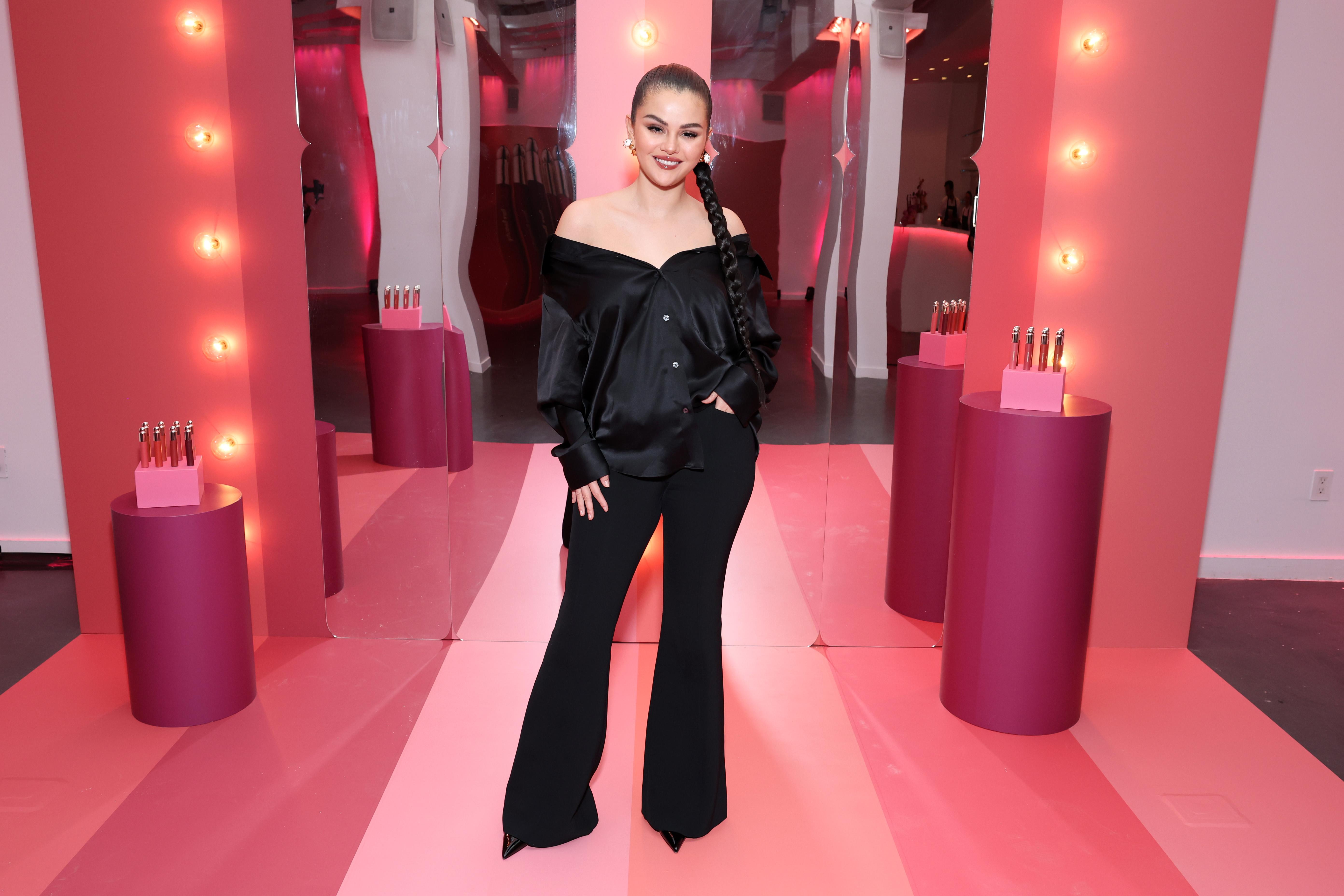 Selena Gomez in a black strapless top and pants.