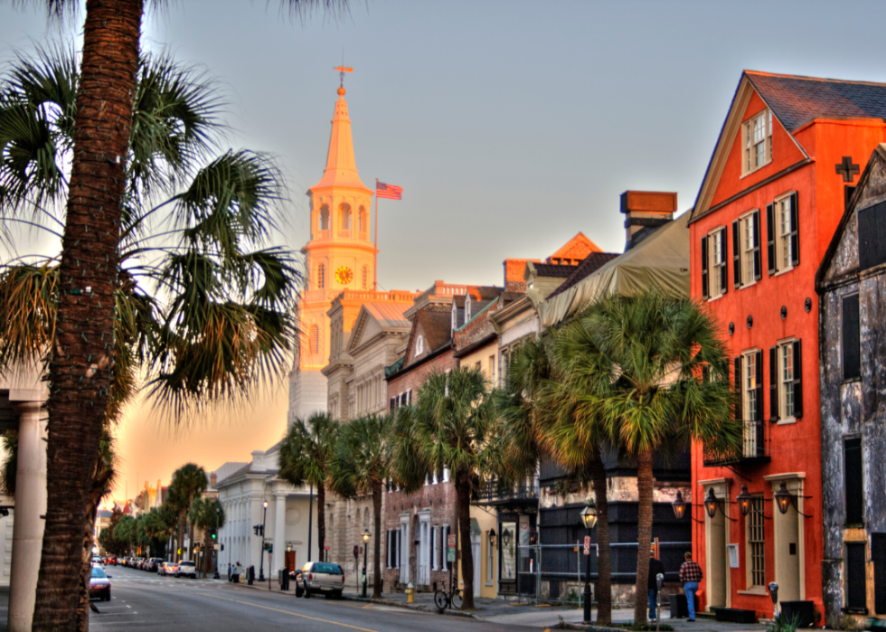 A row of colorful houses with palm trees along the street.