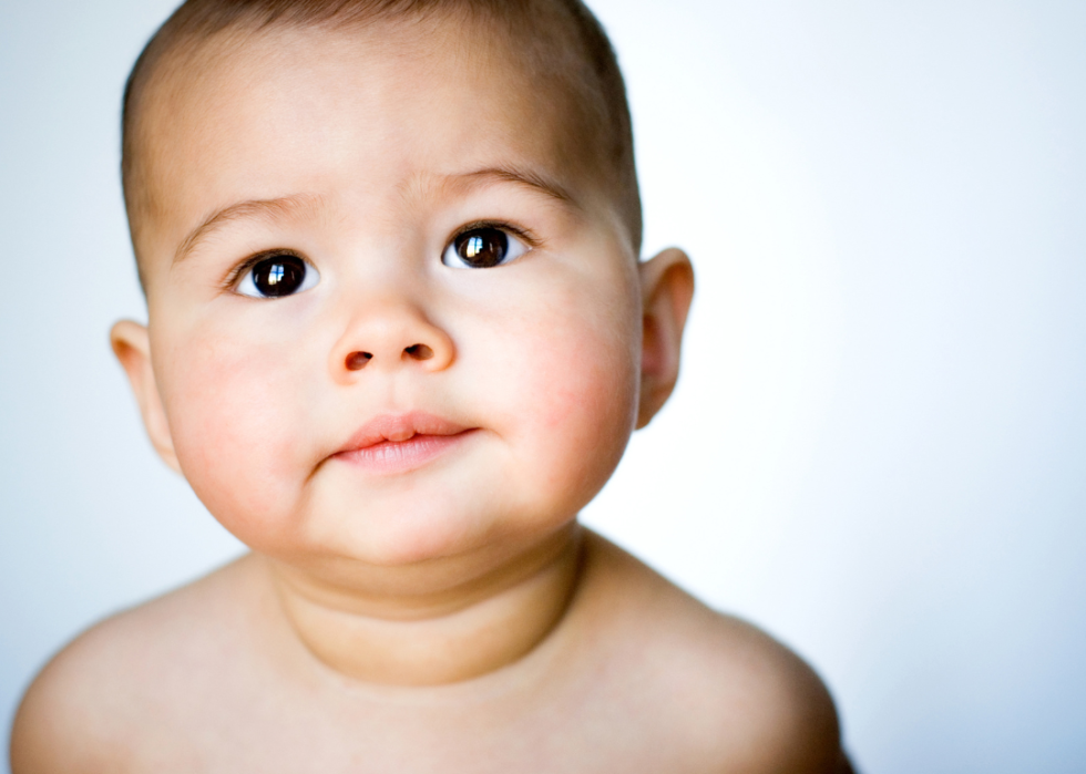 A baby girl with large brown eyes.