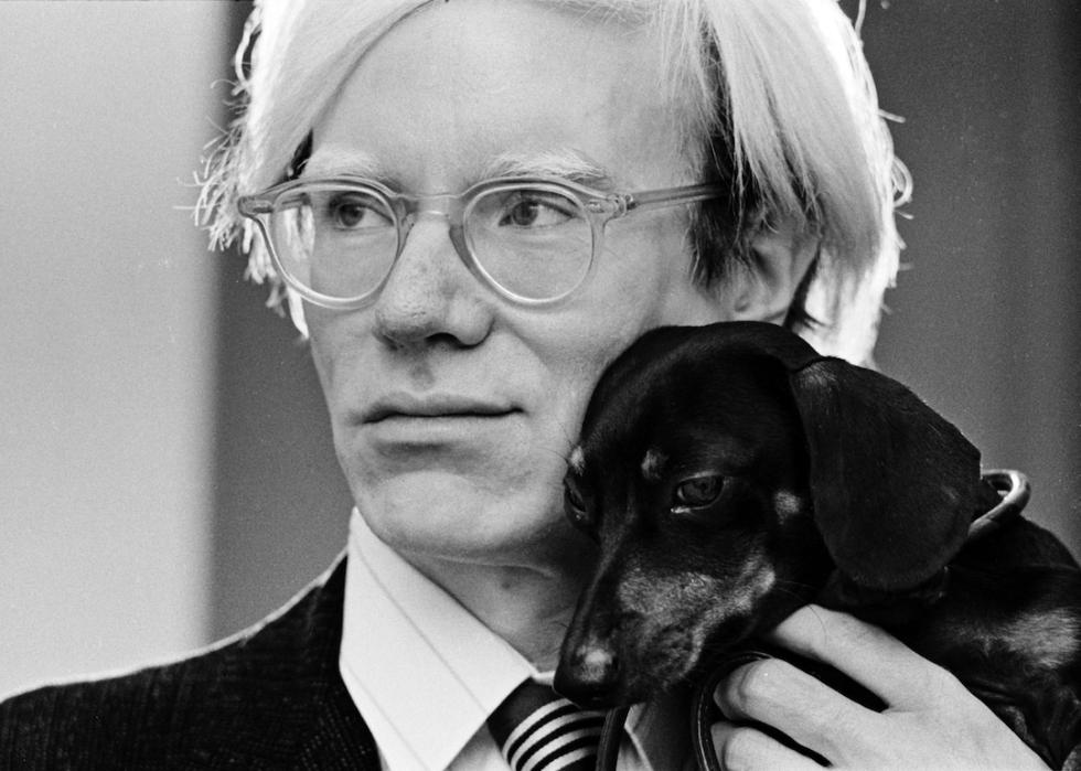 Andy Warhol poses with his beloved dachshund Archie in 1973.