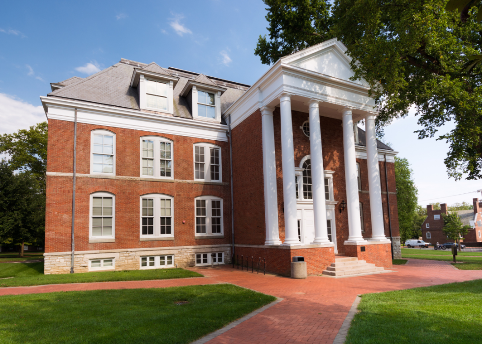 Red brick building with tall white columns.