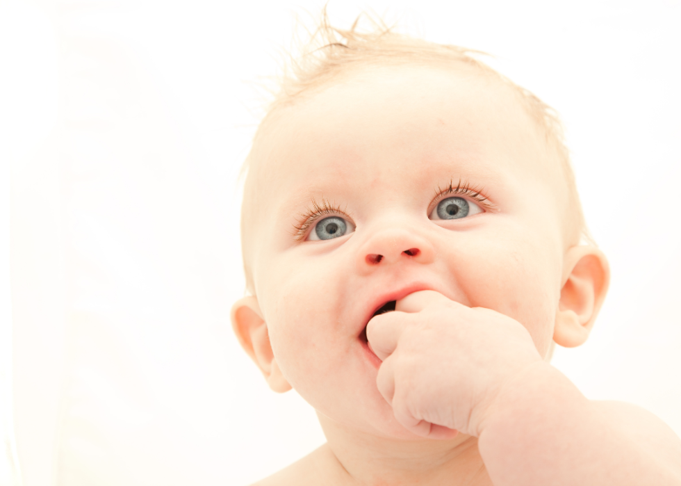 A closeup of a baby boy with blond hair and blue eyes.