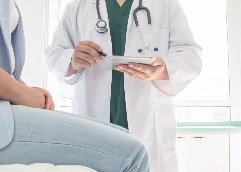 A doctor speaking with a patient in a medical office.