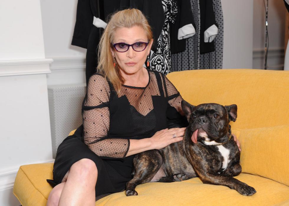 Carrie Fisher attends a fashion event with her French bulldog Gary in 2014 in London, England.