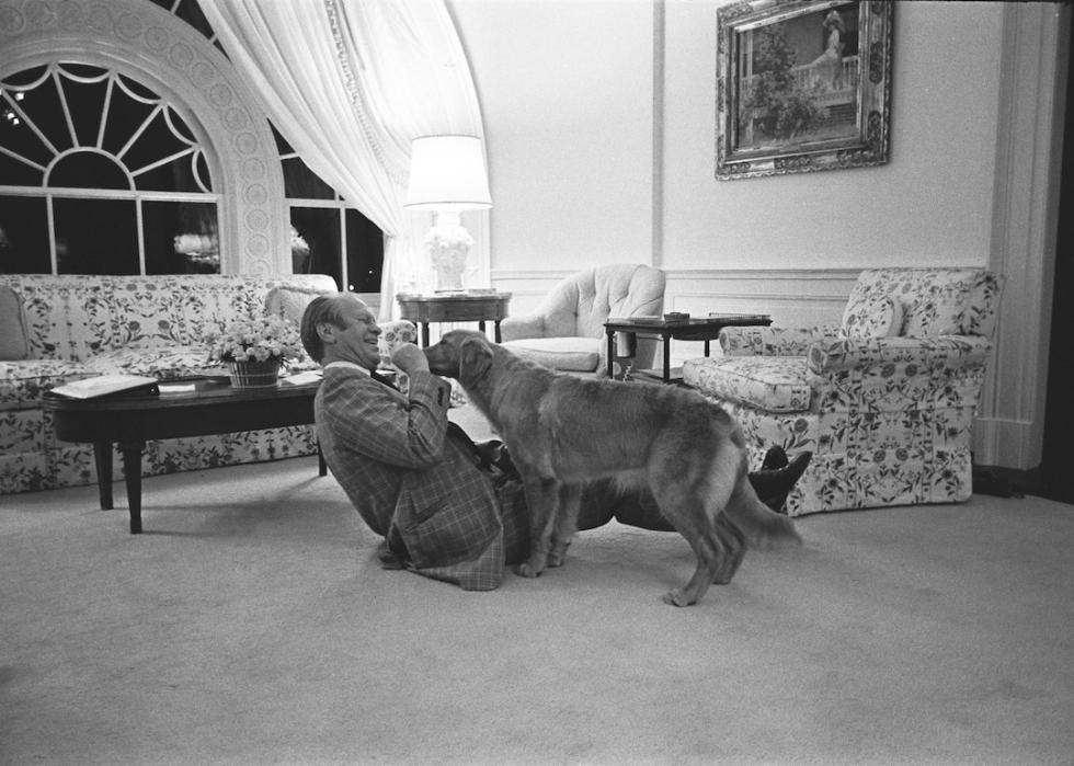 Former President Gerald R. Ford with his new pet golden retriever, Liberty, in the White House Executive Residence in 1975.
