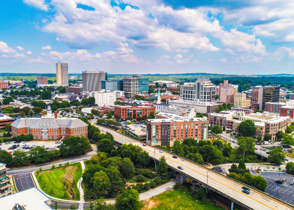 A city downtown with a raised road in the center. 