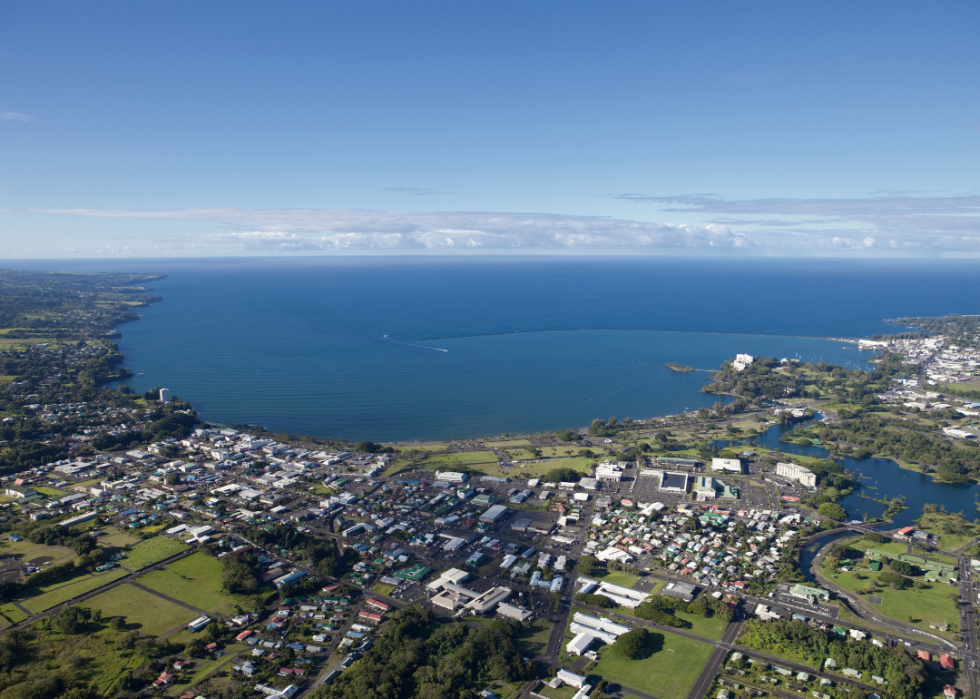 An aerial view of a city by the large body of water.