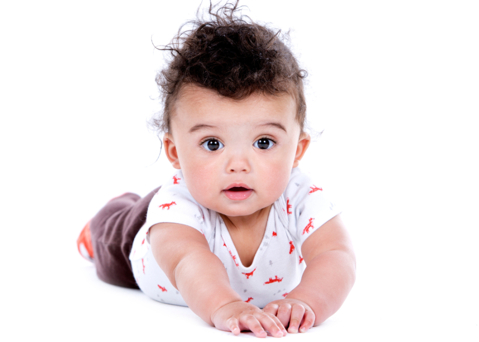 Hispanic baby boy with messy hair.