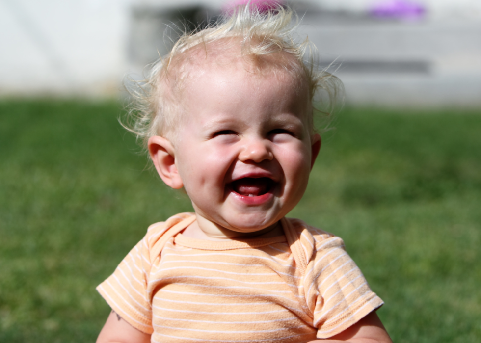 A blond baby boy with a big smile.