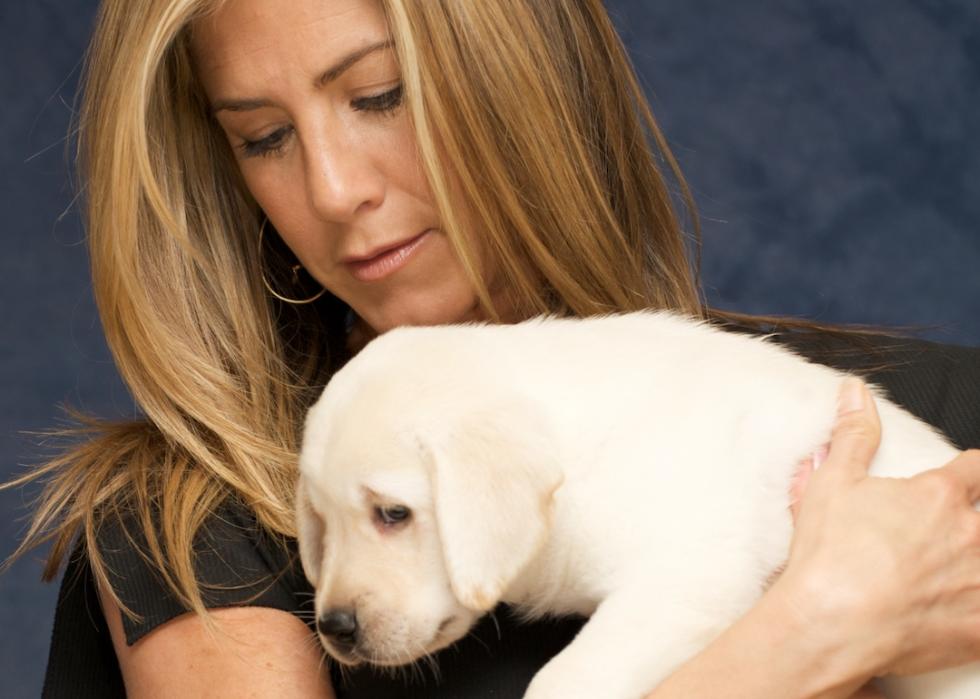 Jennifer Aniston holds a labrador retriever puppy at the "Marley & Me" press conference in Santa Monica, California in 2008.