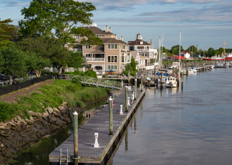 A wooden dock with boats docked in the water.