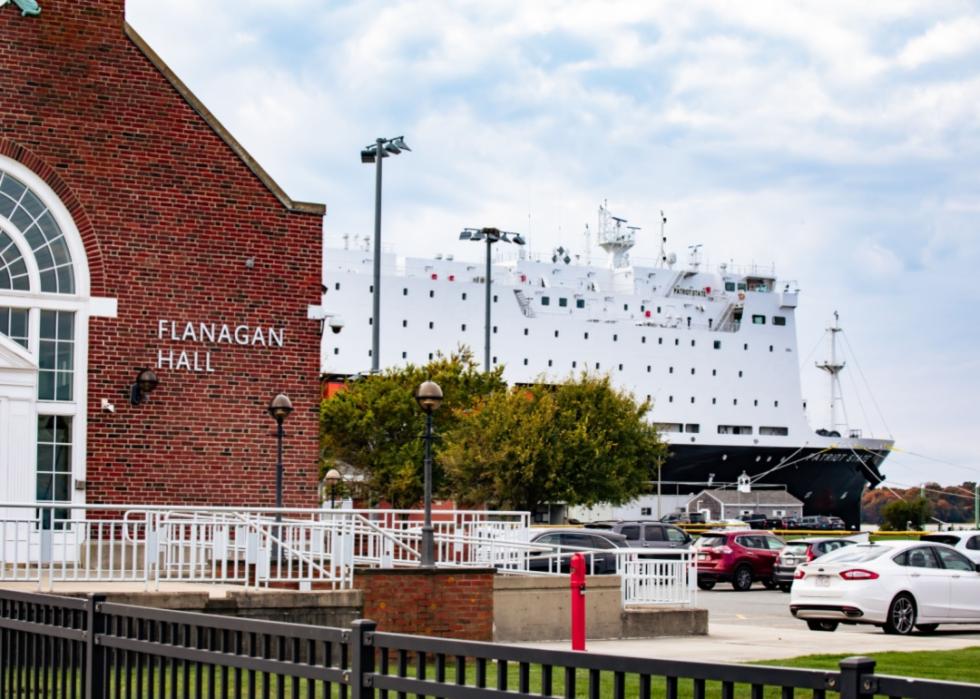 Flanagan Hall at Massachusetts Maritime Academy with a ship in the background.