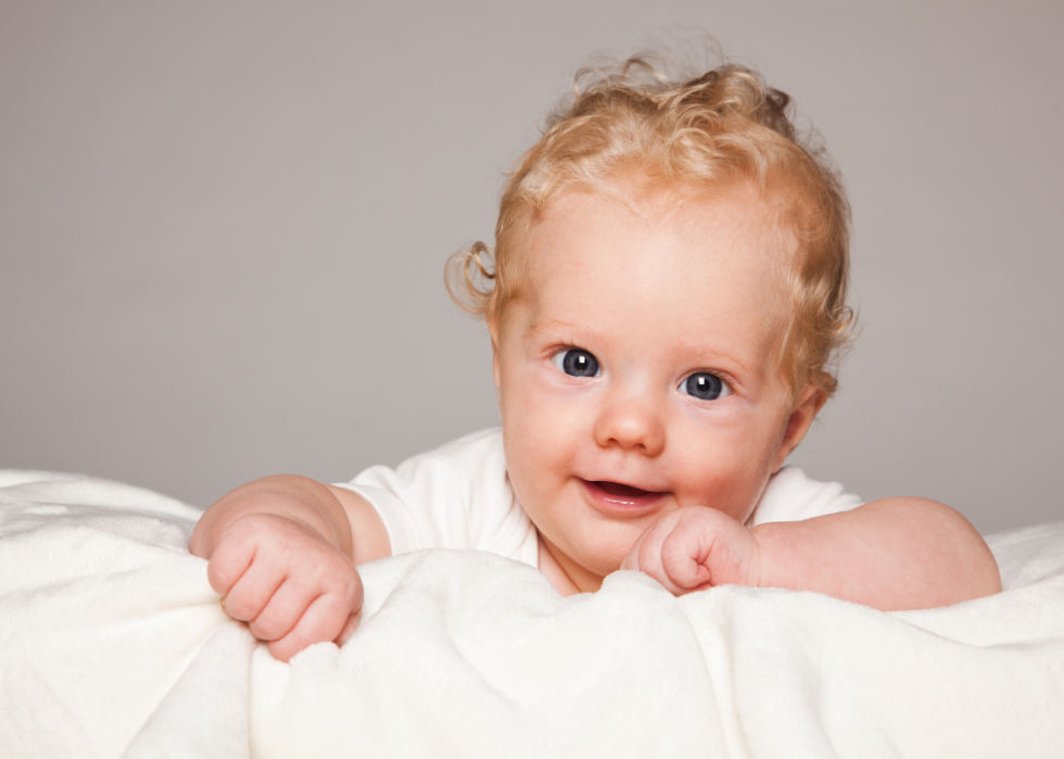 A blond baby boy with curly hair.