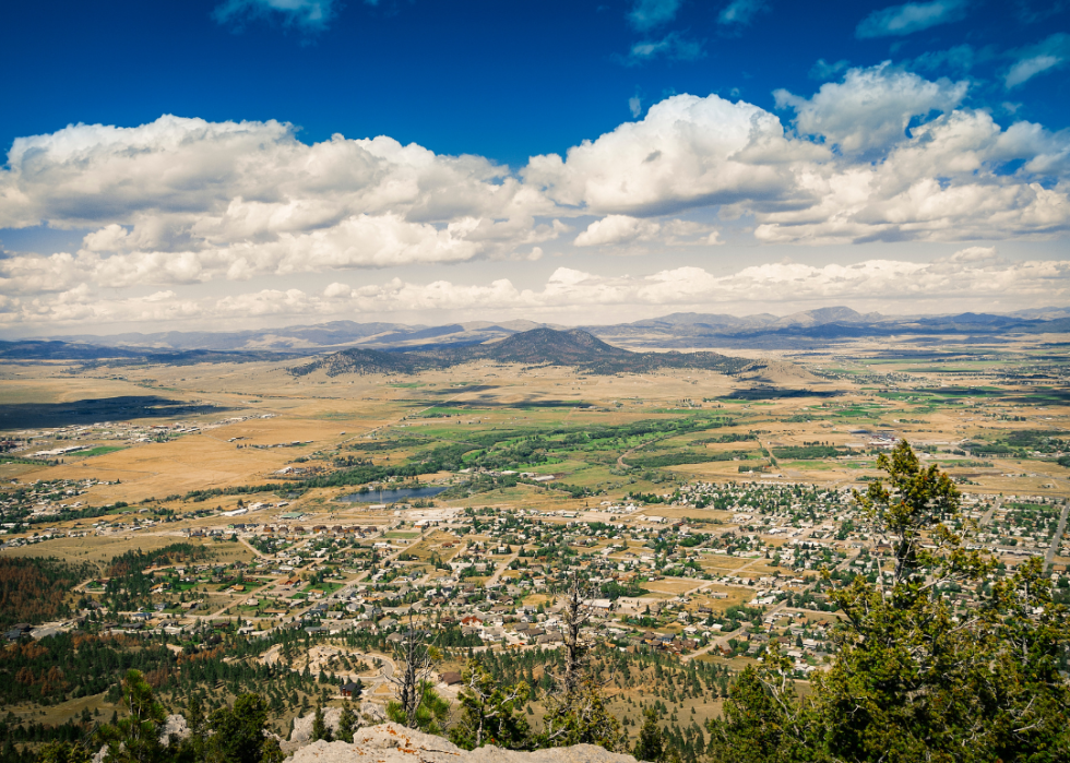 A city in the valley surrounded by tall mountains.