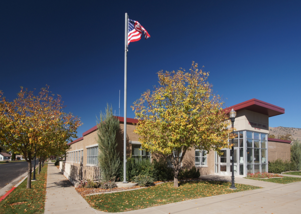 The Morgan City Hall building with an American flag out front.