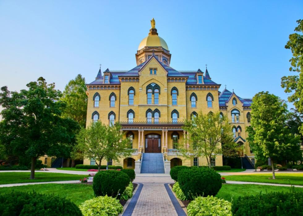 A beautiful building with a golden dome at University of Notre Dame.