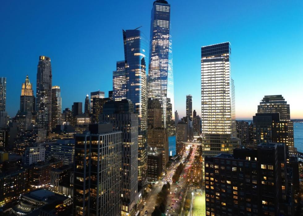 Skyline dominated by several skyscrapers of varying heights with glass facades.