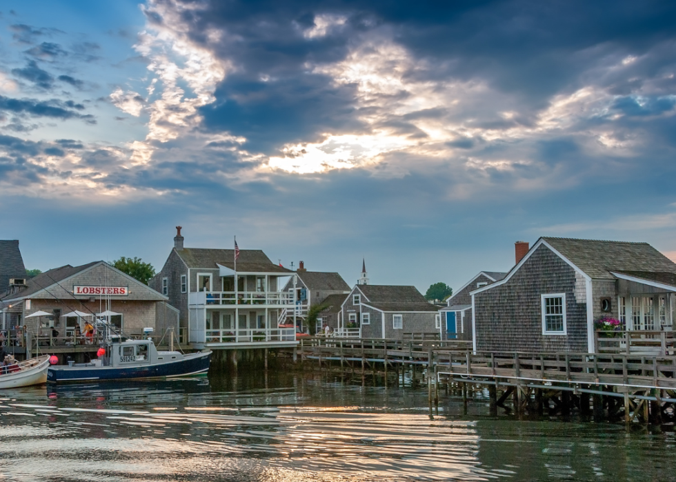A wooden boat docked at a small harbor.