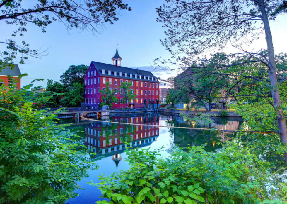 Brick buildings by the body of water.