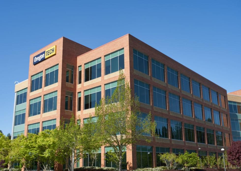 A modern brick four story building with large windows.