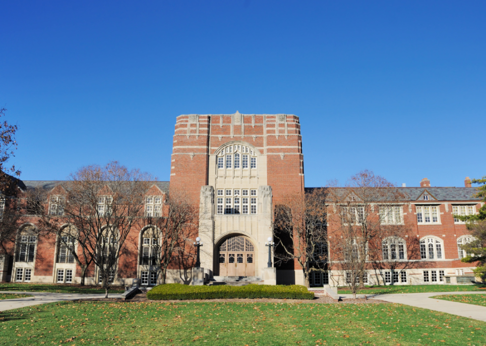 A red brick building with large windows and a tower. 