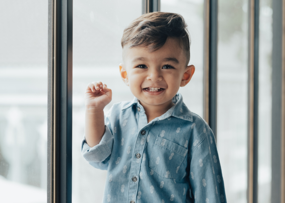 A smiling boy standing. 