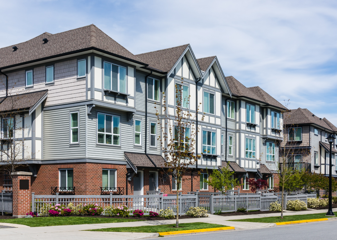 A modern apartment complex painted grey and white.