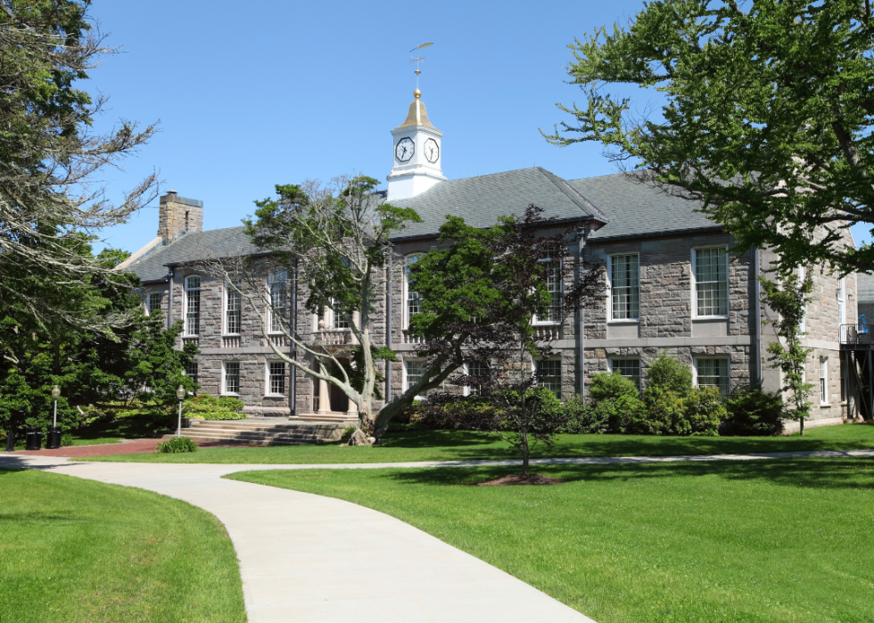 A gray stone building with a white tower top.