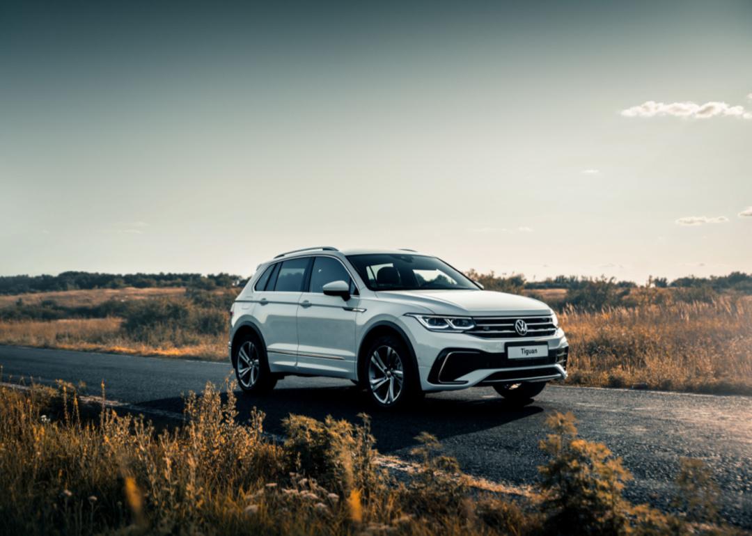A white Volkswagen Tiguan on the road.